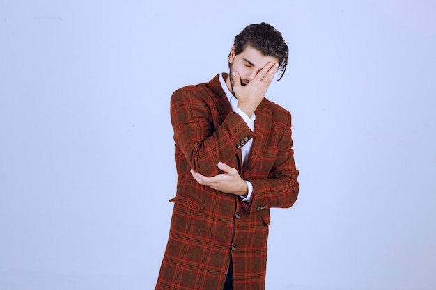 Free photo man in checked jacket feeling very sad about something and crying.