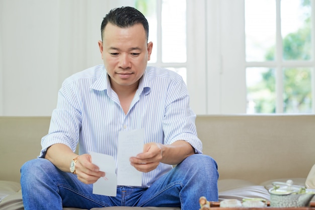 Free photo man checking bills