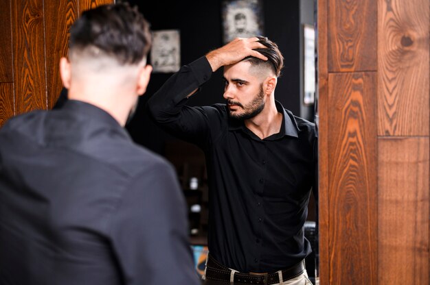 Man checking his new haircut in a mirror