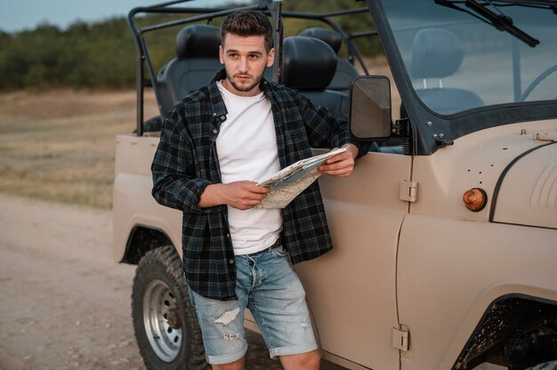 Man checking map while traveling by car alone