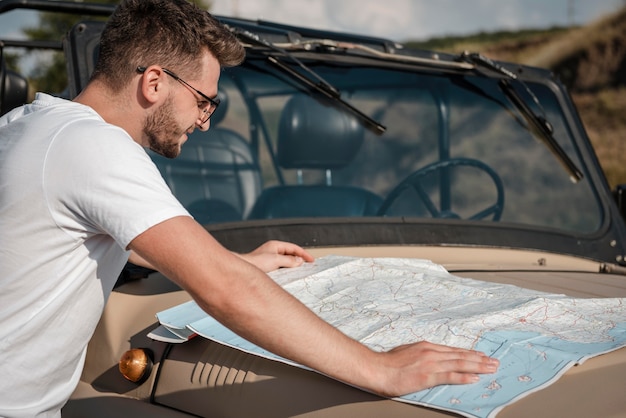 Man checking map while traveling by car