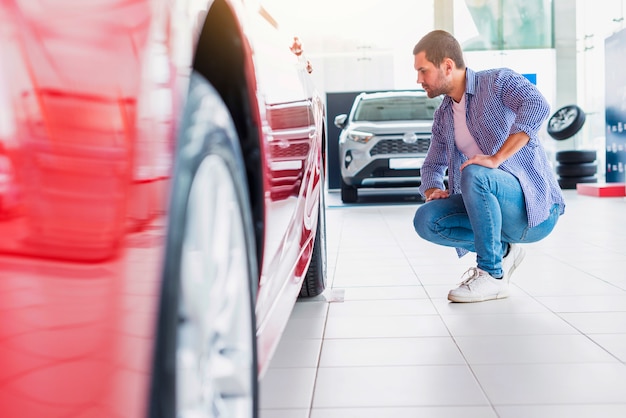 Free photo man checking out new car