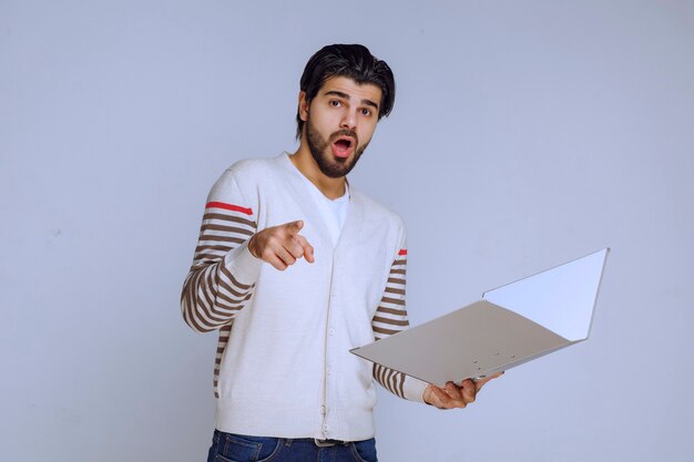 Man checking the reporting folder and asking the colleague what he means there.