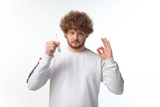 Man checking temperature on white wall