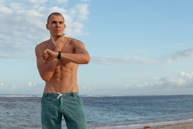 A man checks his pulse after training. bali