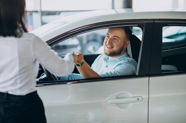 Man choosing a car in a car saloon