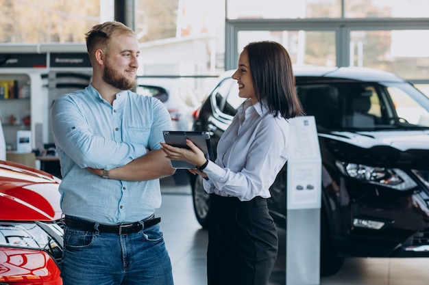 Man choosing a car and talking with salesperson