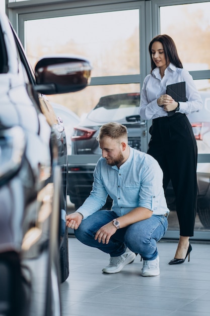 Man choosing a car and talking with salesperson