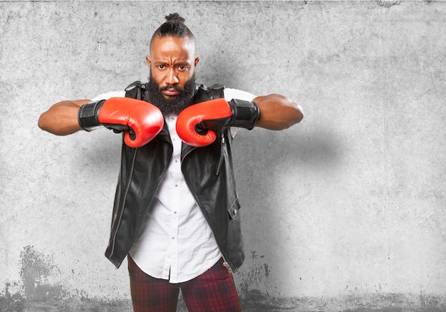 Man clashing his fists with boxing gloves