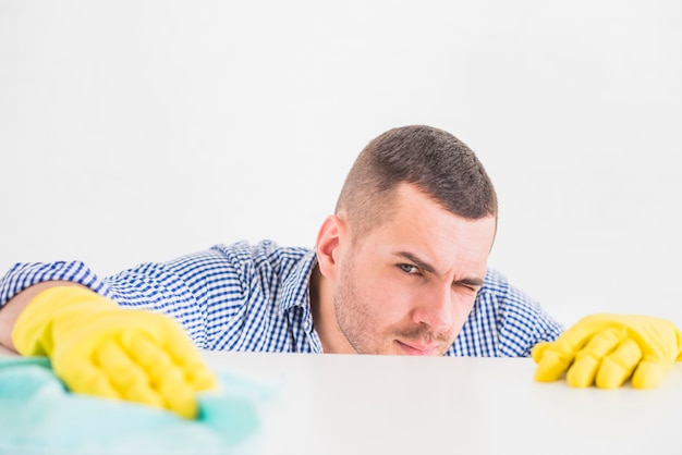 Free photo man cleaning his home