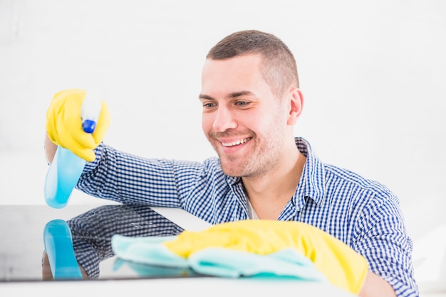 Free photo man cleaning his home