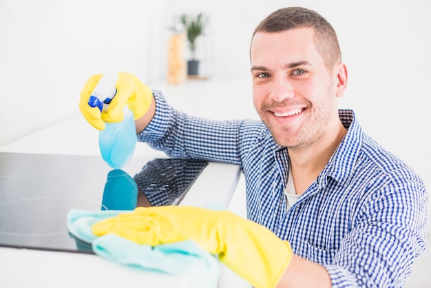 Free photo man cleaning his home