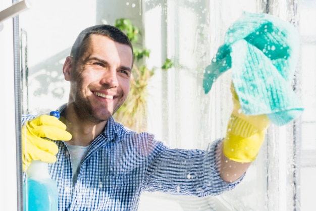 Free photo man cleaning his home