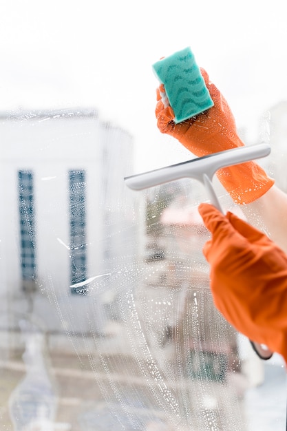 Free photo man cleaning windows