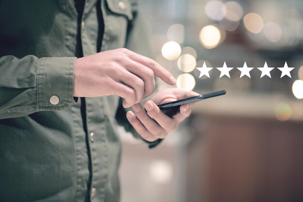 A man clicks on the phone screen and gives a star rating. concept evaluation