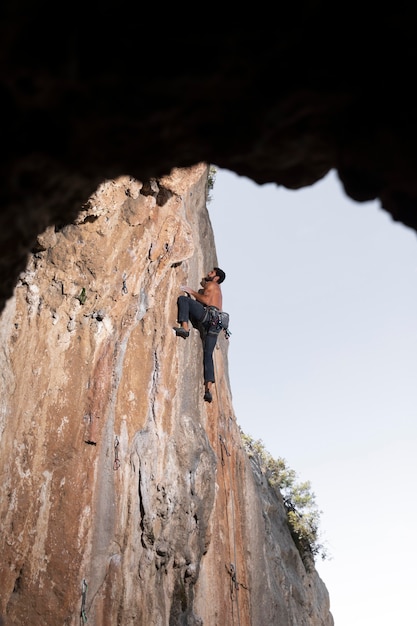 Man climbing on a mountain with safety equipment