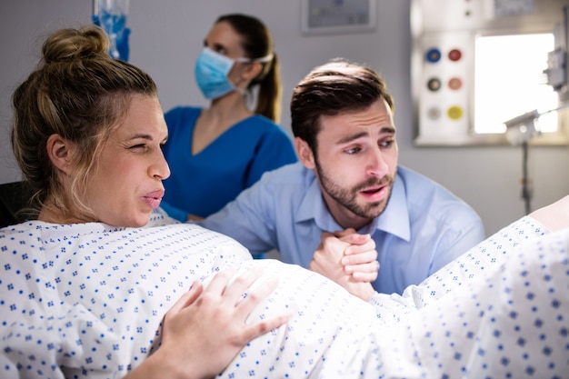 Man comforting pregnant woman during labor