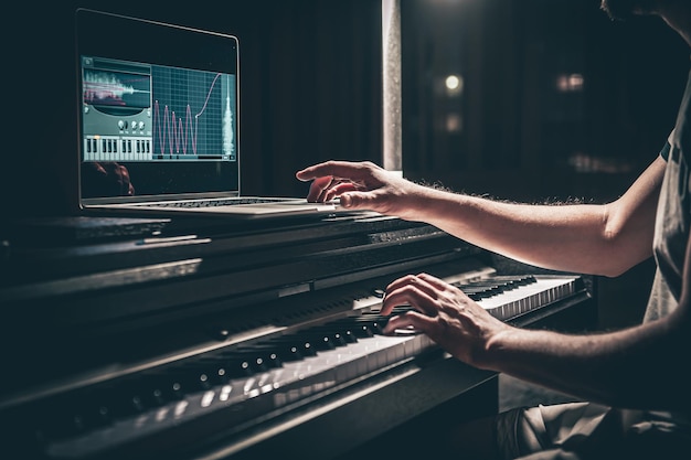 A man composer producer arranger songwriter musician hands arranging music