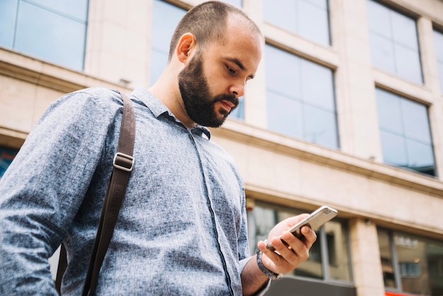 Man concentrated on smartphone at street