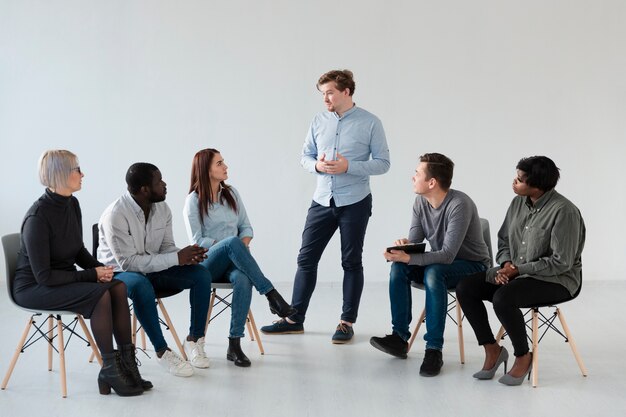 Man confessing in front of other patients