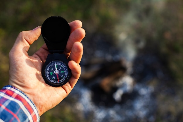 Man consulting compass while camping