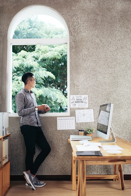 Free photo man contemplating in office