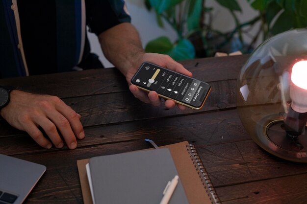 Man controlling a smart lamp with his phone