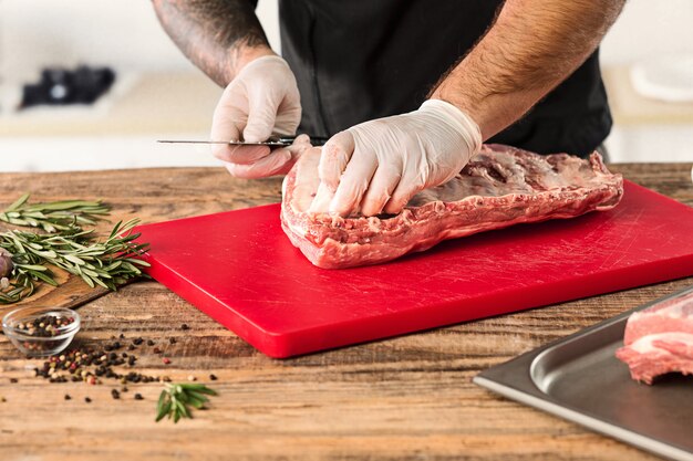 Man cooking meat steak on kitchen