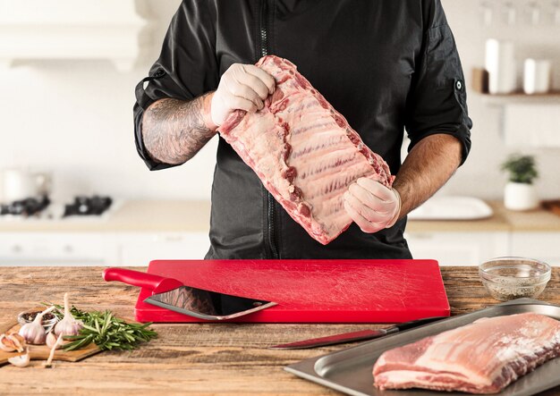 Man cooking meat steak on kitchen