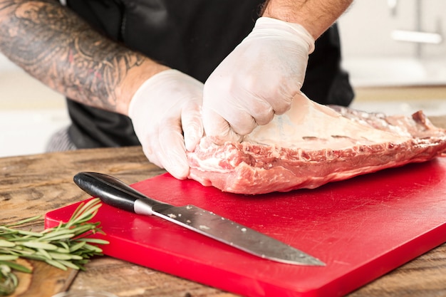 Man cooking meat steak on kitchen