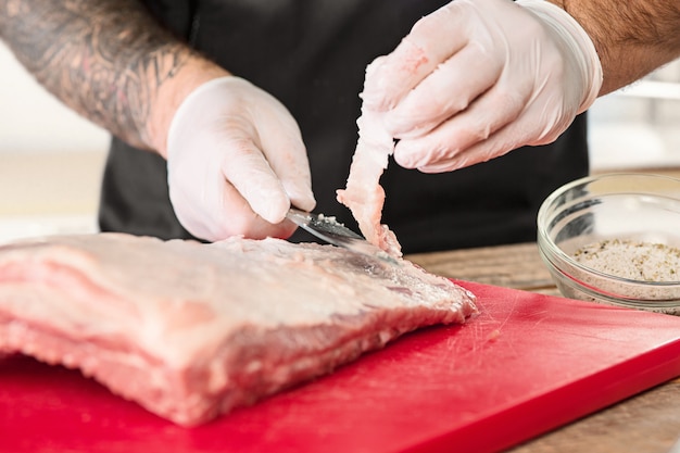 Man cooking meat steak on kitchen