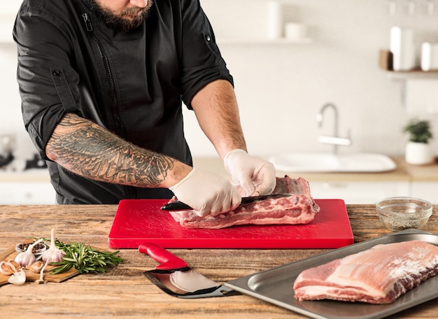 Man cooking meat steak on kitchen