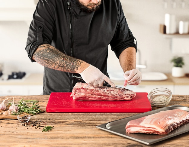 Man cooking meat steak on kitchen