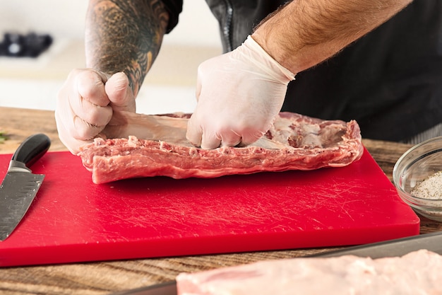 Man cooking meat steak on kitchen