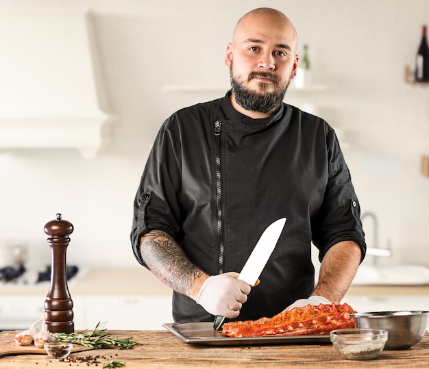 Man cooking meat steak on kitchen