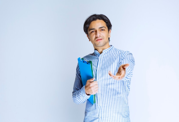 Man correcting mistakes and returning report folders to his colleague. High quality photo