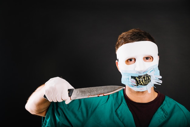 Free photo man in costume threatening with knife