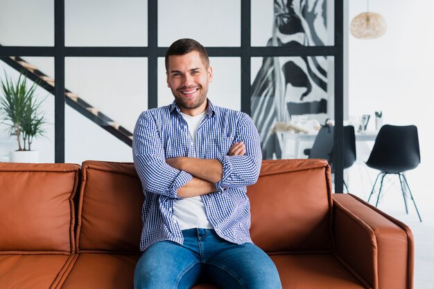 Man on couch with arms crossed