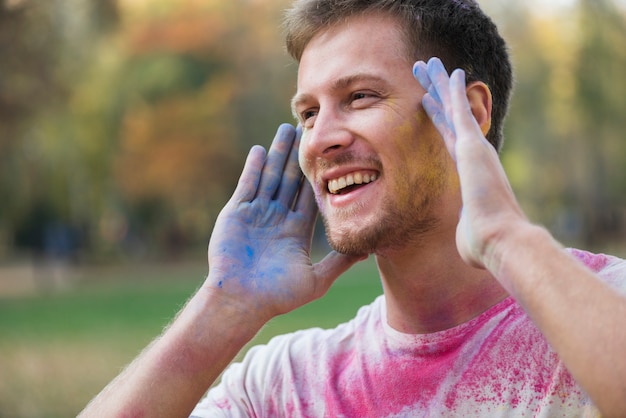 Man covered in different colors at holi