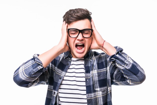 Man covering his ears with hands in front of white wall