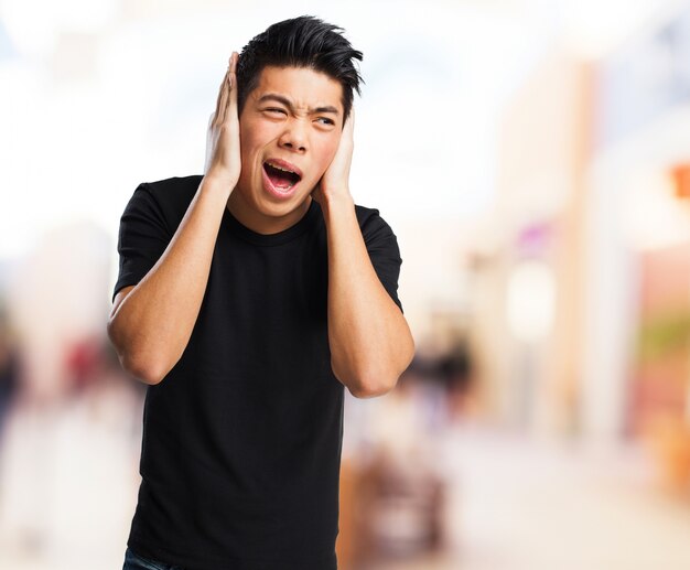 Man covering his ears