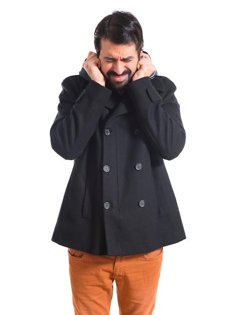 Man covering his ears