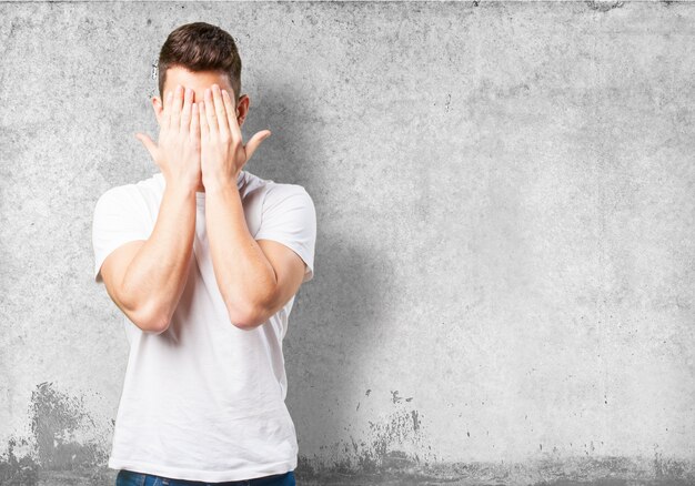 Man covering his face with his hands