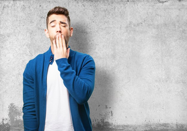 Man covering his mouth while yawning