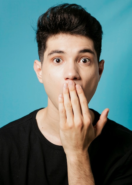 Man covering his mouth with hand