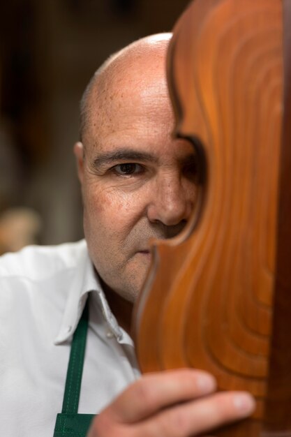 Man crafting an instrument in his workshop