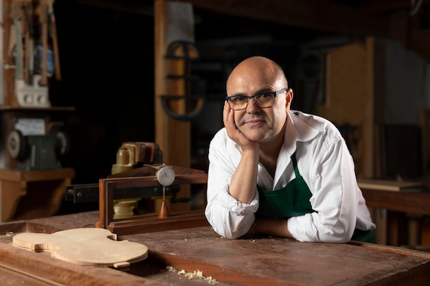 Man crafting an instrument in his workshop