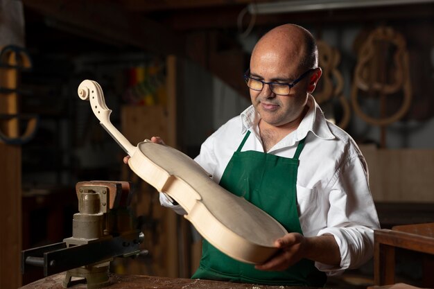 Man crafting an instrument in his workshop