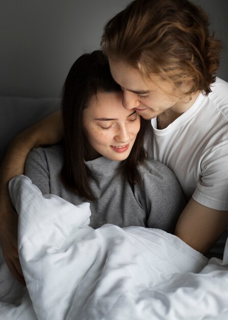 Man cuddling with girlfriend