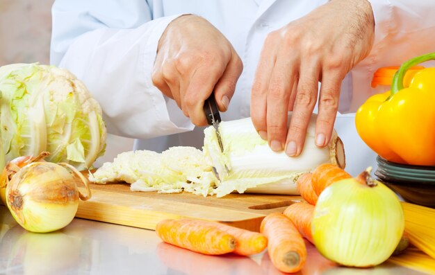 man cuts lettuce